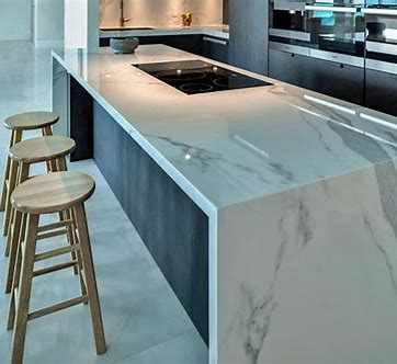 Kitchen design options of waterfall edge.  Marbled white granite edge on dark cabinetry